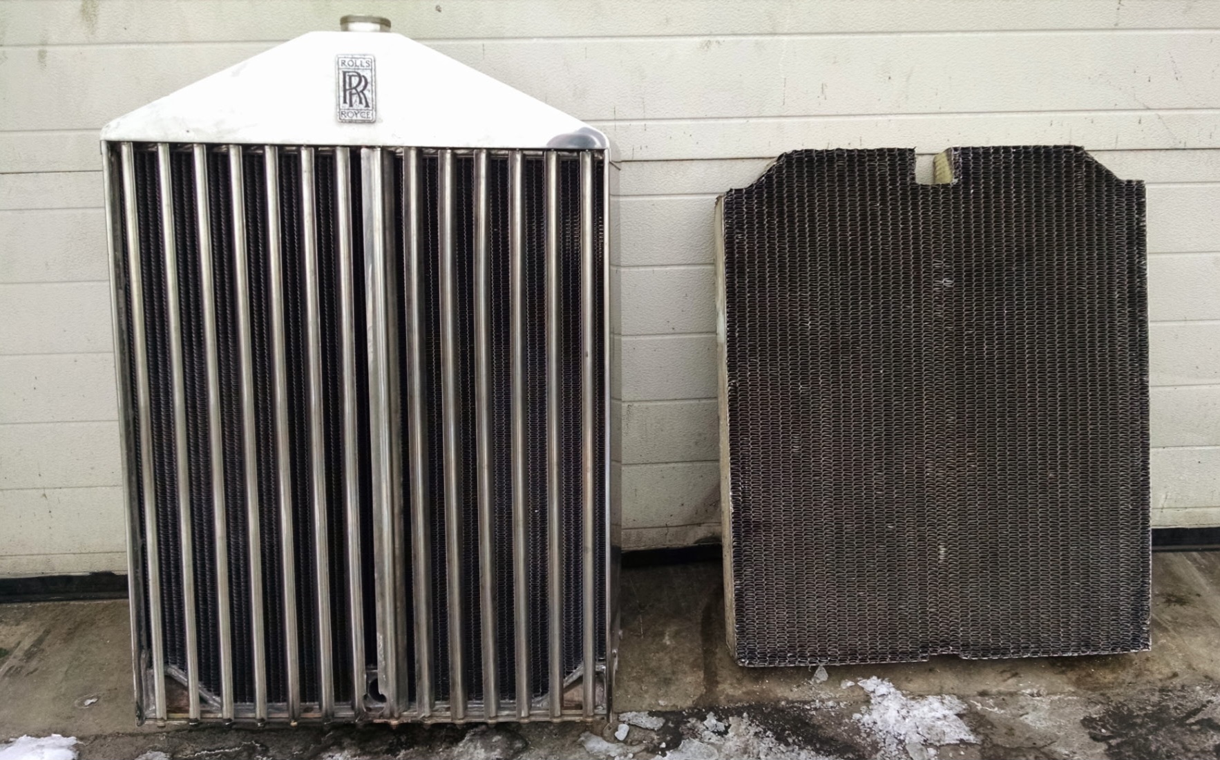 Worn original Rolls-Royce core next to the rebuilt radiator
